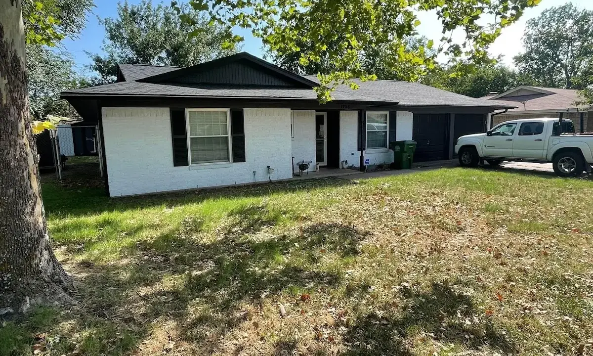 Professional roofing crew working on a residential roof in Whitestown